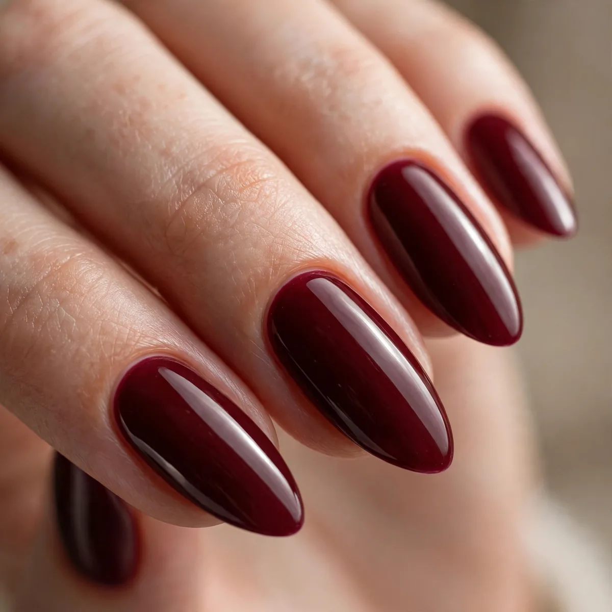 Deep burgundy almond-shaped nails