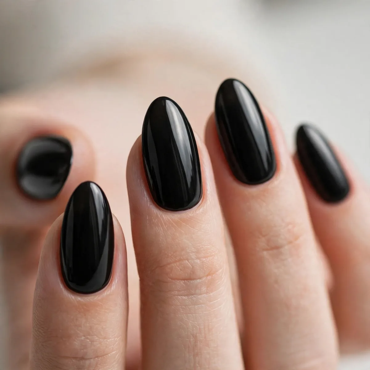 Black polish on almond-shaped nails