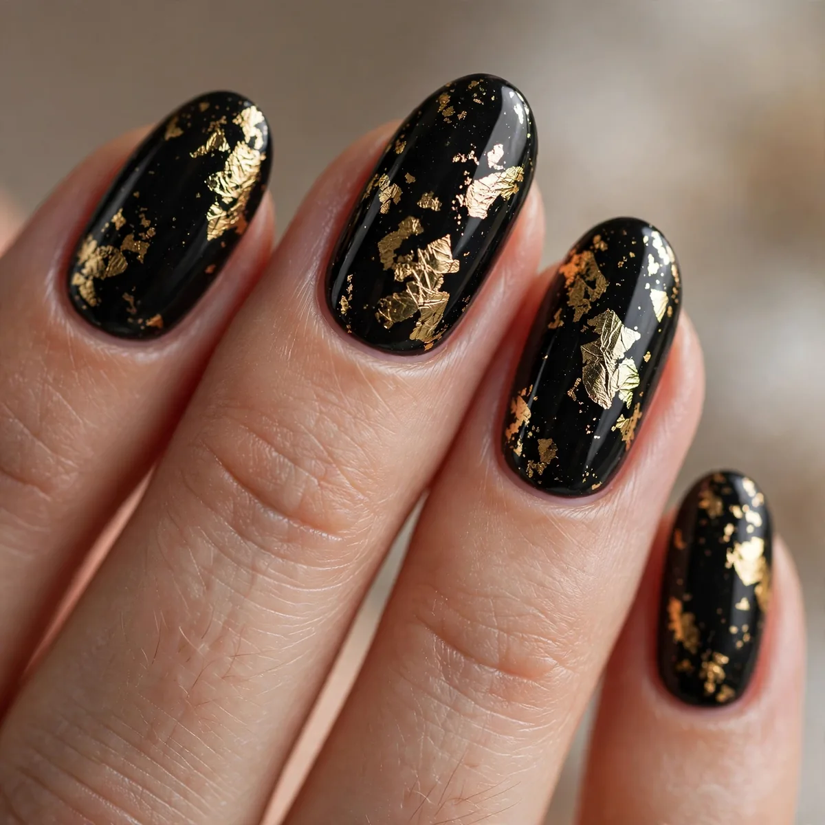Gold foil on black nails