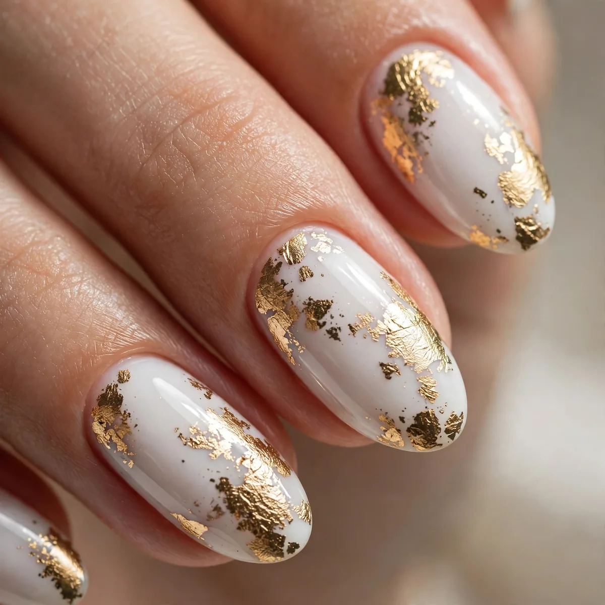 Gold foil on white nail polish
