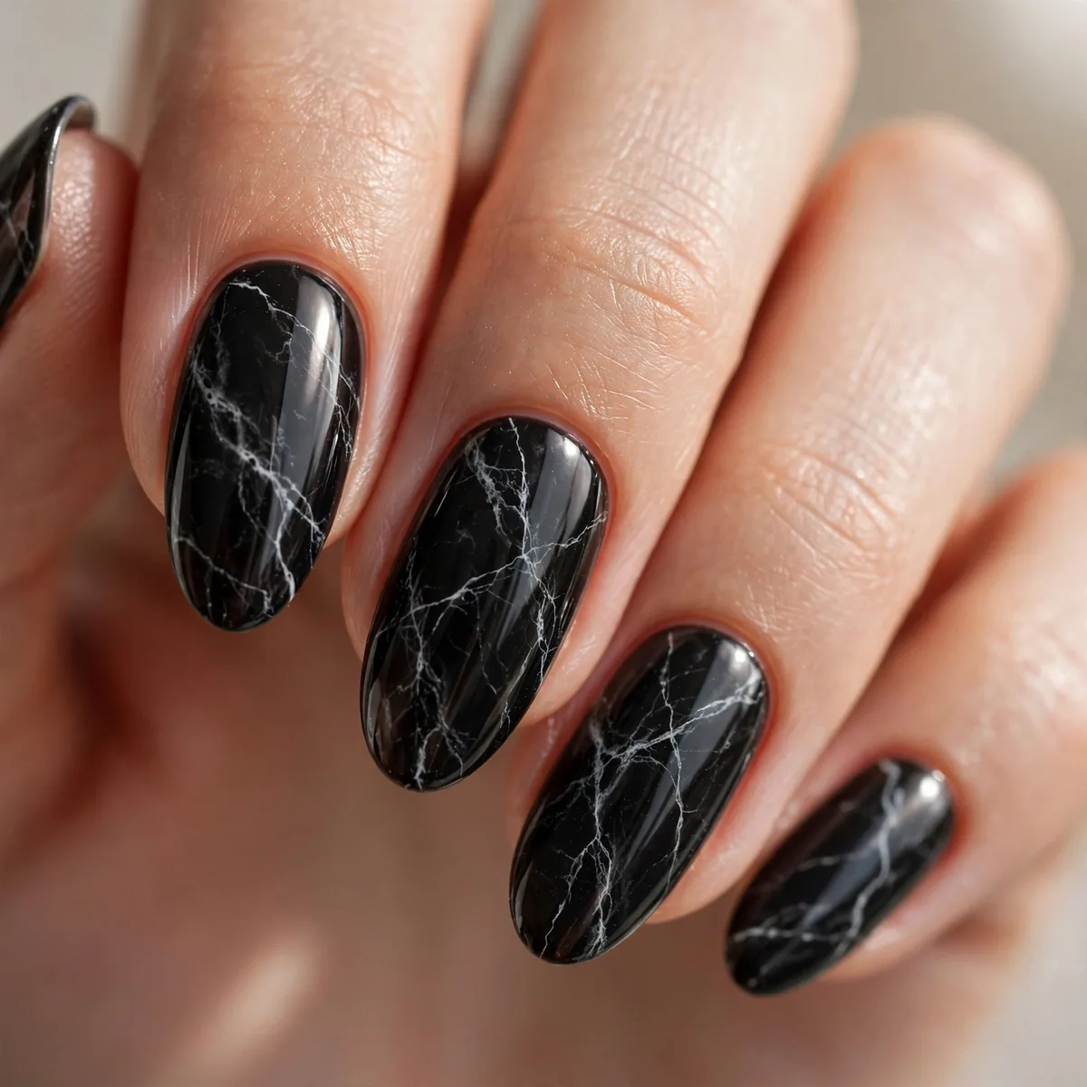 Black marble nail art with white veins